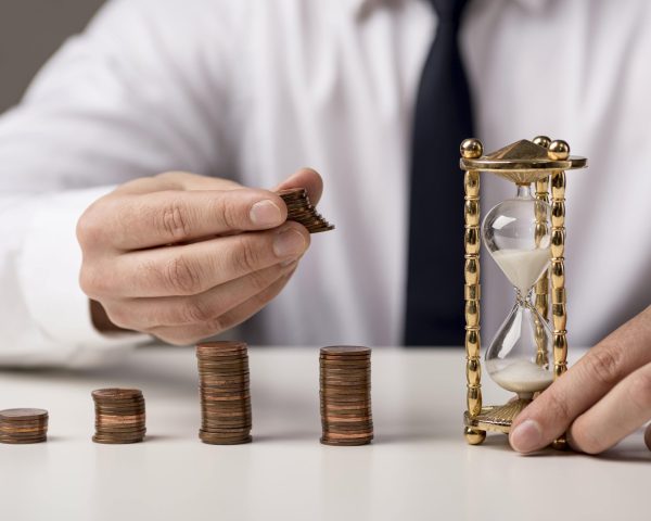 front-view-businessman-with-coins-hourglass-min