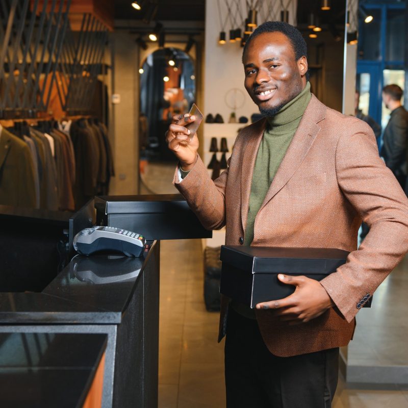 happy-african-shopper-holding-boxes-of-new-clothes-2024-02-02-23-43-28-utc-min