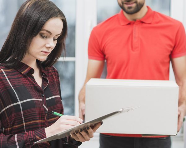 woman-signing-receipt-near-crop-courier